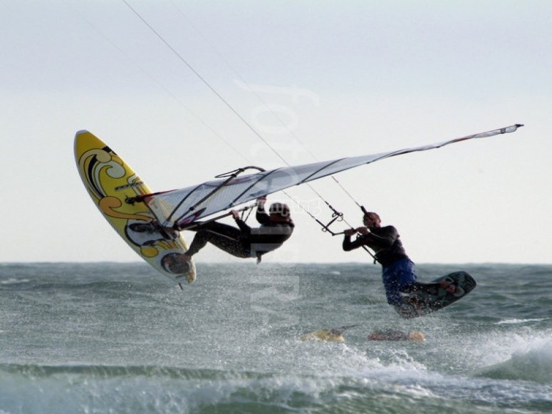 Windsurfer and kitesurfer together Windsurfer and kitesurfer together
